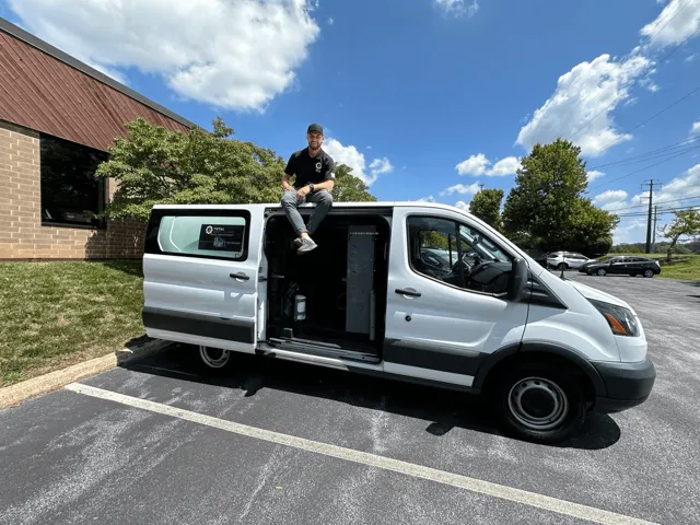 TAS technician with a silver service van